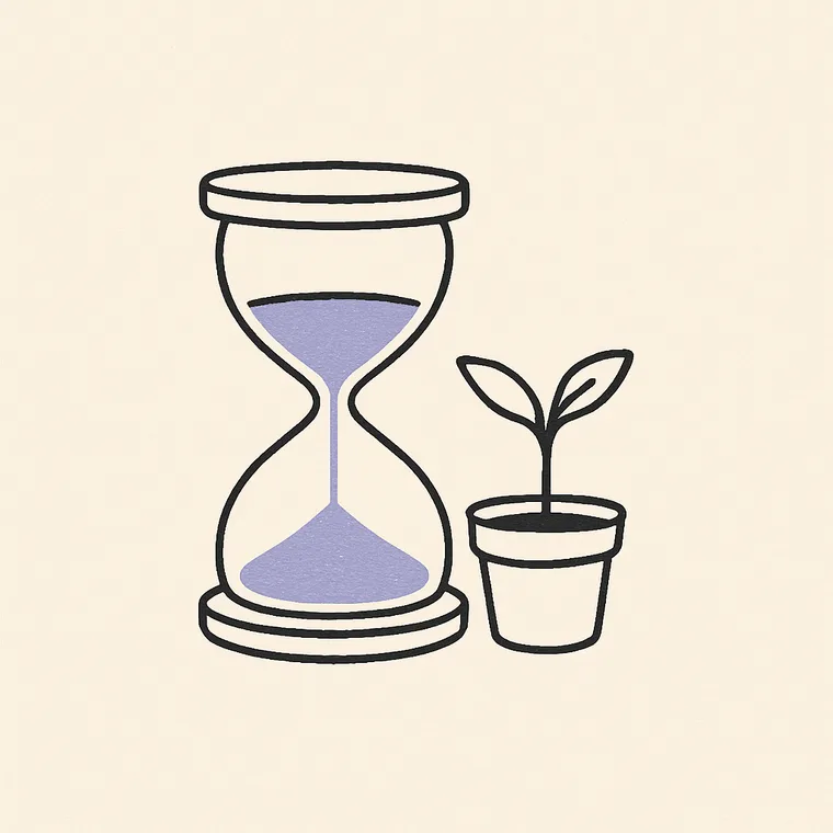 An hourglass beside a small potted seedling